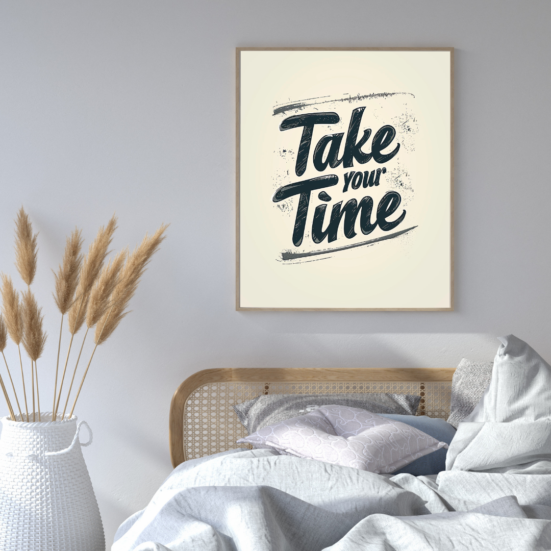 Gråvit minimalist typografiväggposter med texten "Take Your Time" av Nordanio, inramad och monterad på vägg.