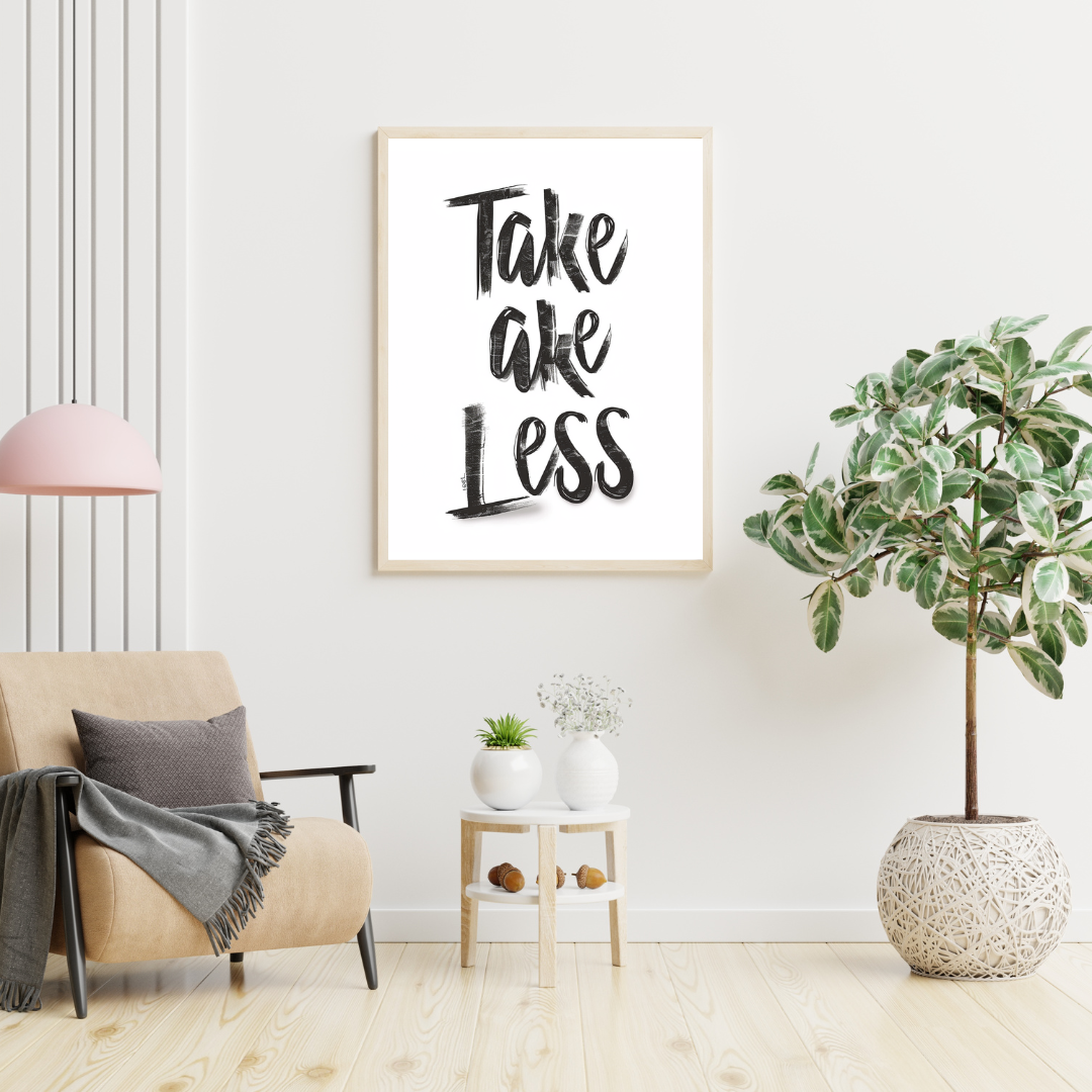 Vit minimalist typografiposter med texten "Take Less" från Nordanio, väggkonst för modern inredning.